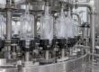 “Bottle washing machine showing bottle holders and washing station” — use only if these details are visible.